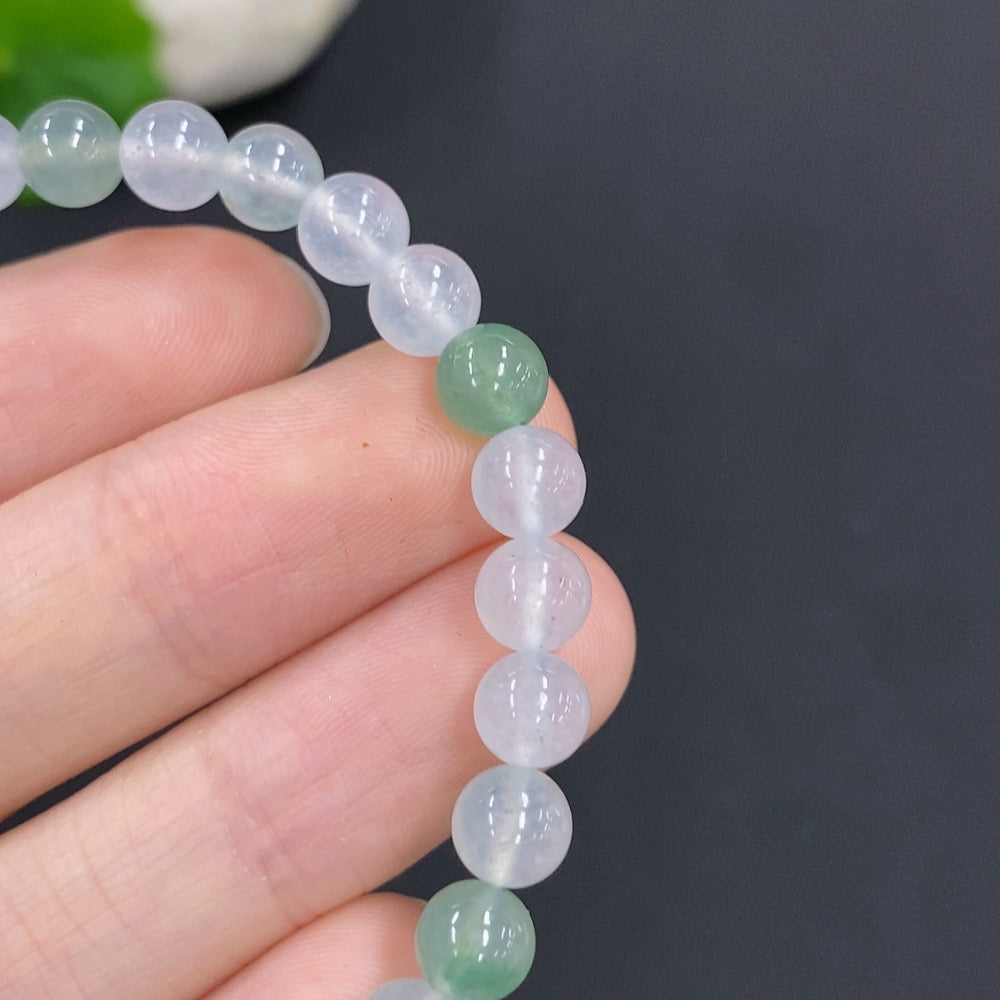 HUILIU HQ jadeite bracelet with 11.4g weight and 5.9mm wide smooth jade beads, natural green color, close-up view.