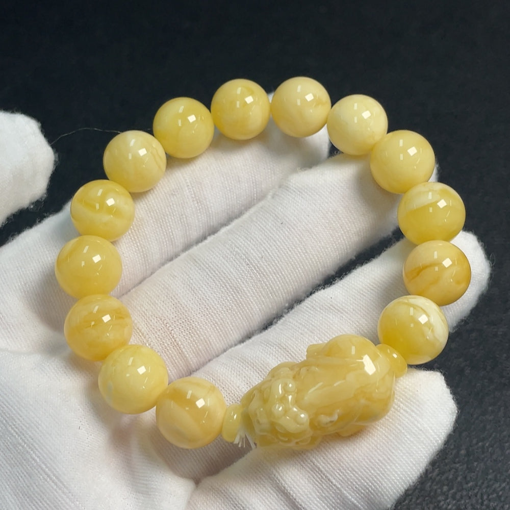 Amber and beeswax bracelet with 11.1-14.2mm amber beads, total weight 14g, from HUILIU HQ, shown on a white background.
