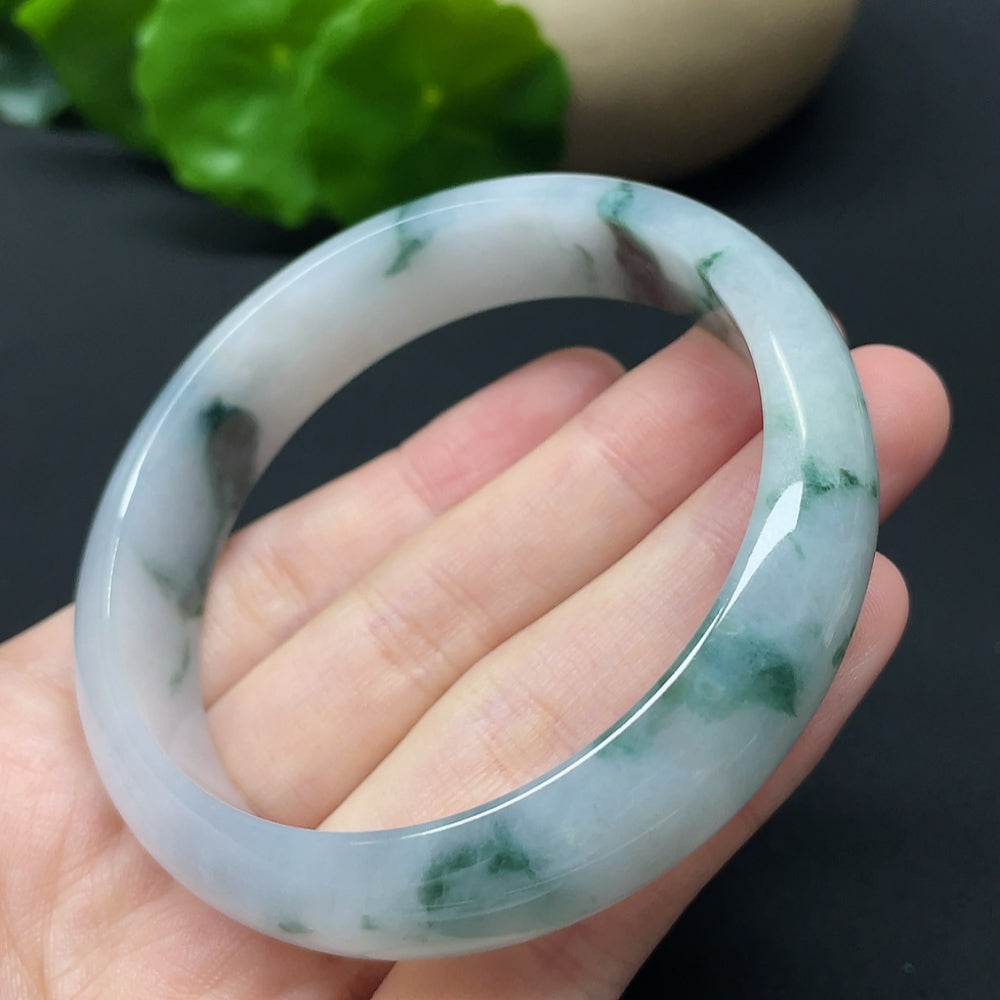 HKHQ jadeite round bangle with mineral components, weight 54.31g, size 57.9, showcasing smooth polished surface and vibrant green color.