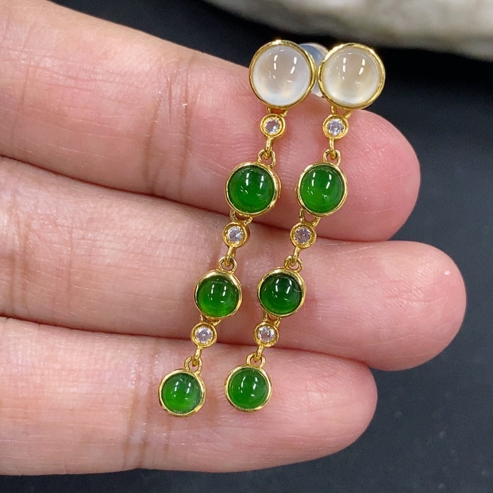 HKHQ jadeite cabochon earrings in 18K gold, showcasing smooth green gemstone settings and elegant earring design.