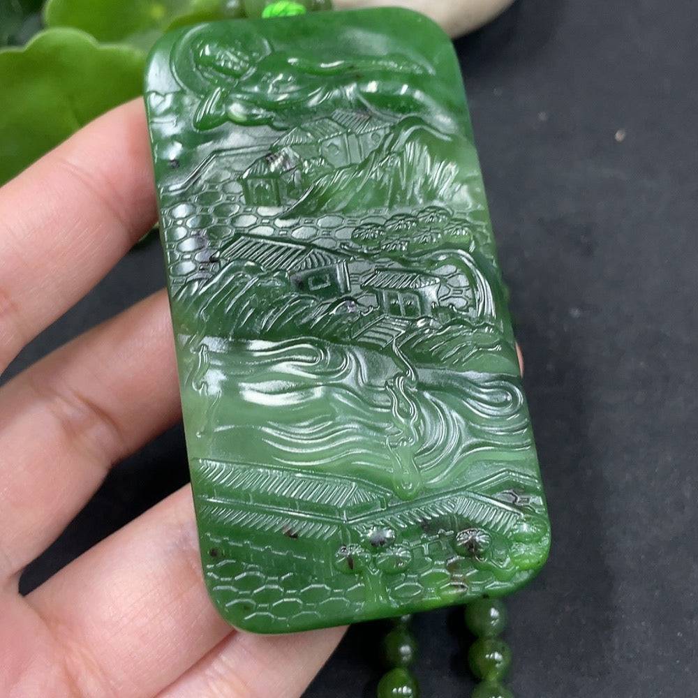 Huiliu Hetian Jade Buddha pendant depicting the Buddha observing the world, crafted from green jade with intricate details.