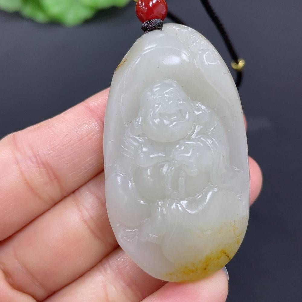 Huiliu certified Hetian jade pendant featuring a detailed Buddha figure, showcasing smooth green jade craftsmanship.