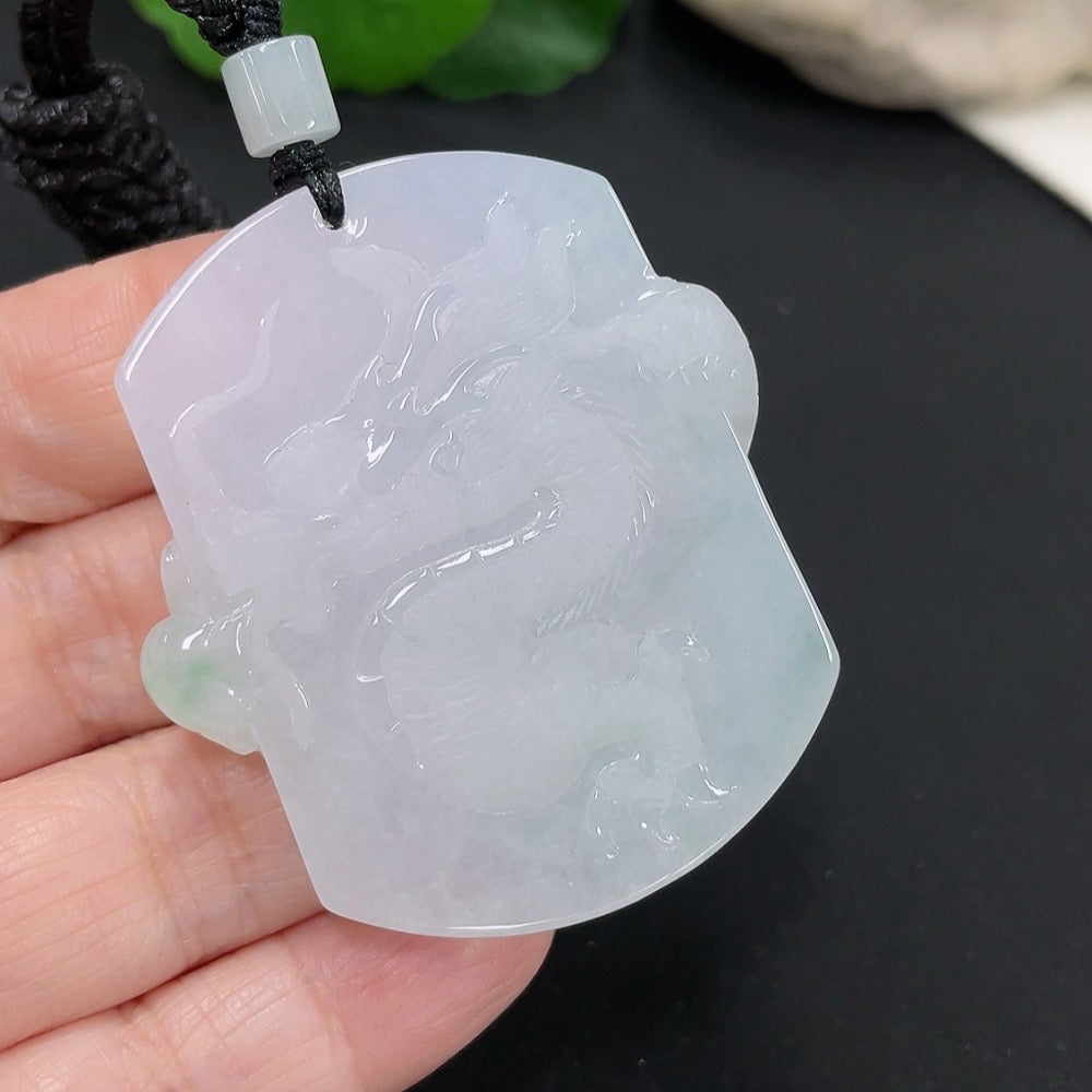 Jadeite dragon pendant with detailed carving, weighing approximately 34.52g, displayed with a rope for wearing, by HUILIU HQ.