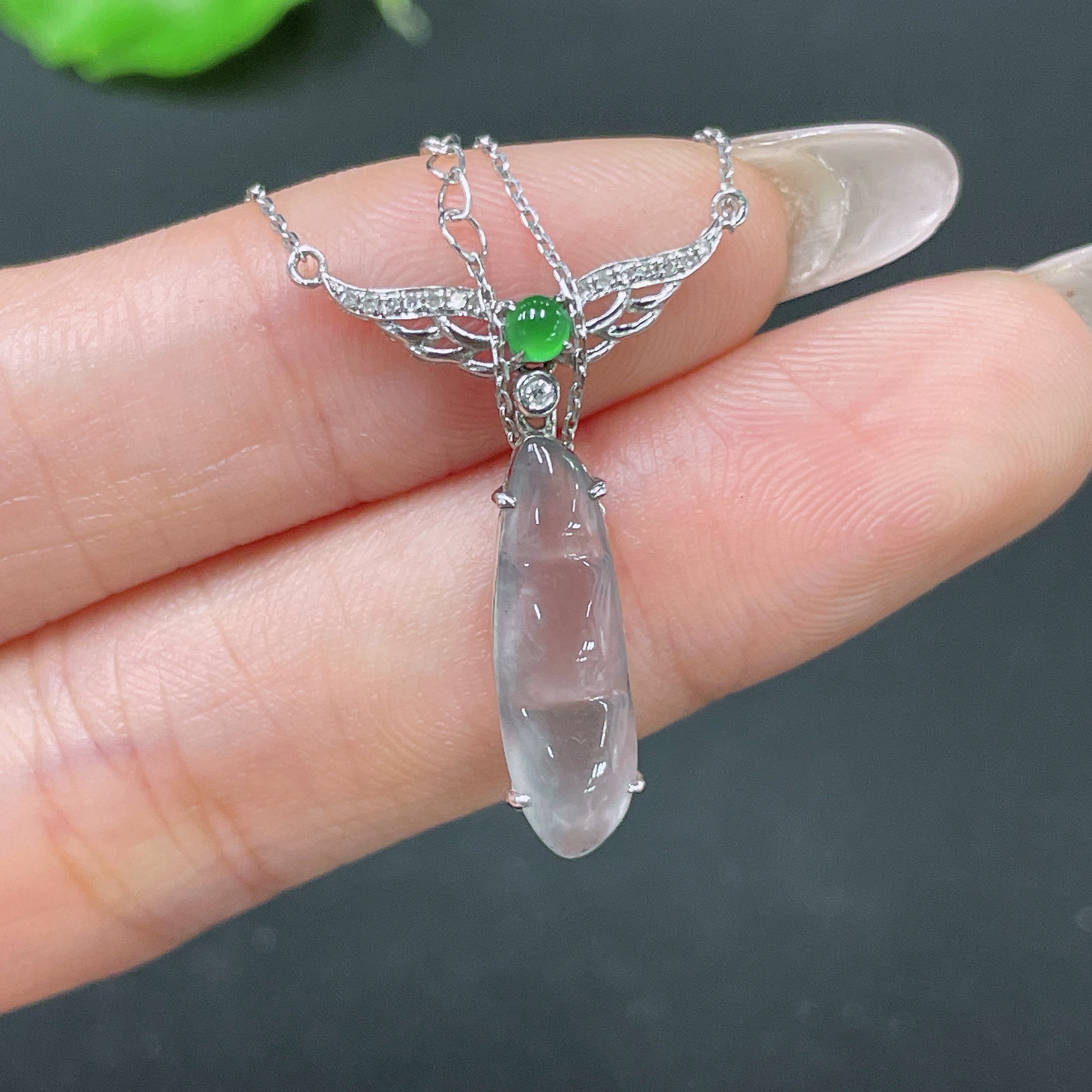 HUILIU HQ jadeite bean pendant in 18k gold with diamond accents, attached to a delicate chain, weighing approximately 2.74g.