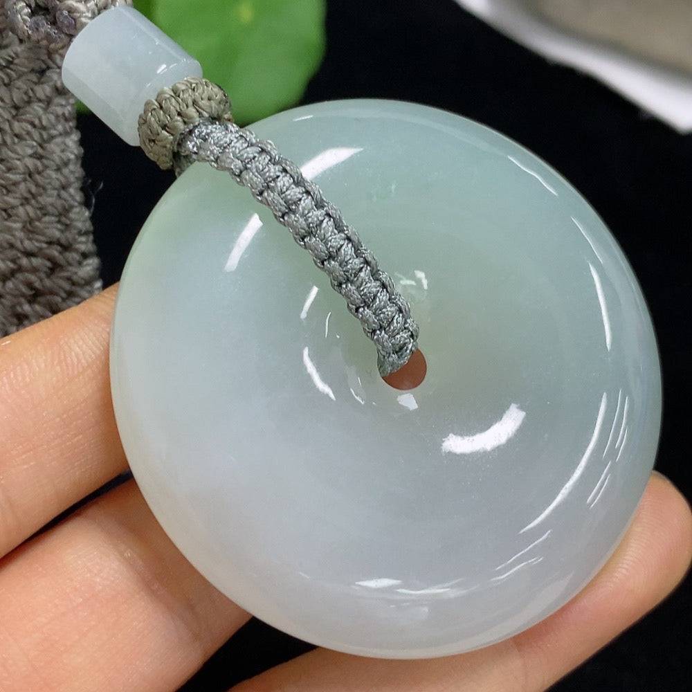 Huiliu Jadeite Peace Knot pendant with rope weight, featuring intricate jade craftsmanship and natural green hues.
