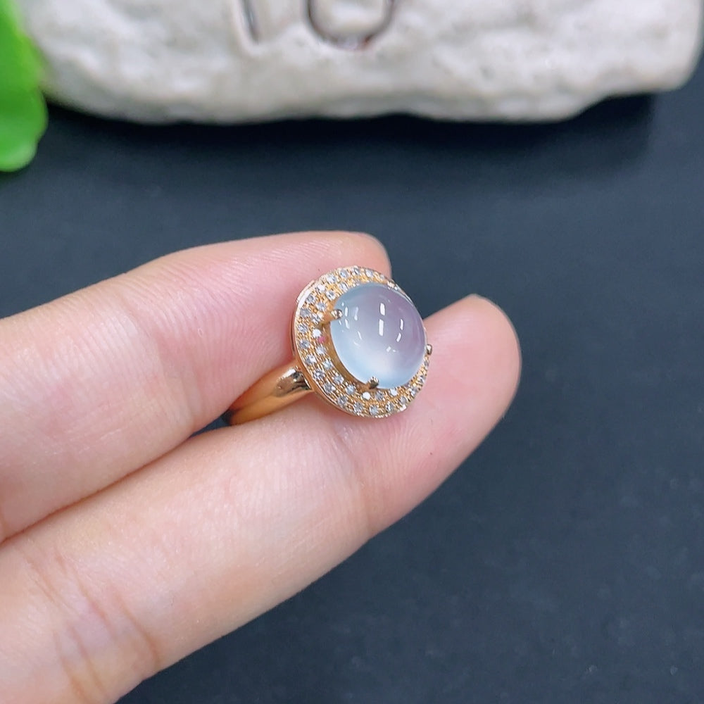 Jadeite ring with 18k gold and diamond side stones, size 14, featuring a smooth green jade centerpiece and sparkling accents.