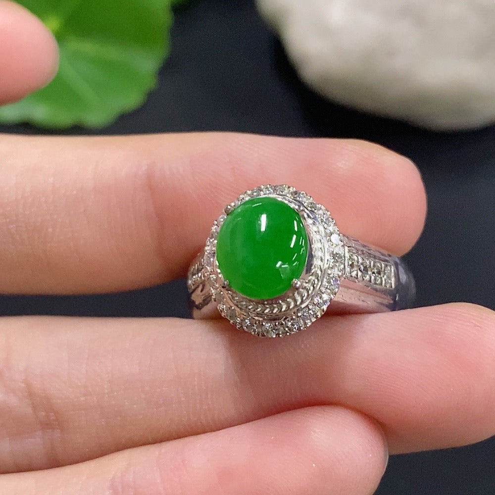 Jadeite cabochon jewelry with a non-gold setting, featuring smooth, polished green gemstone in a decorative silver-style mount.
