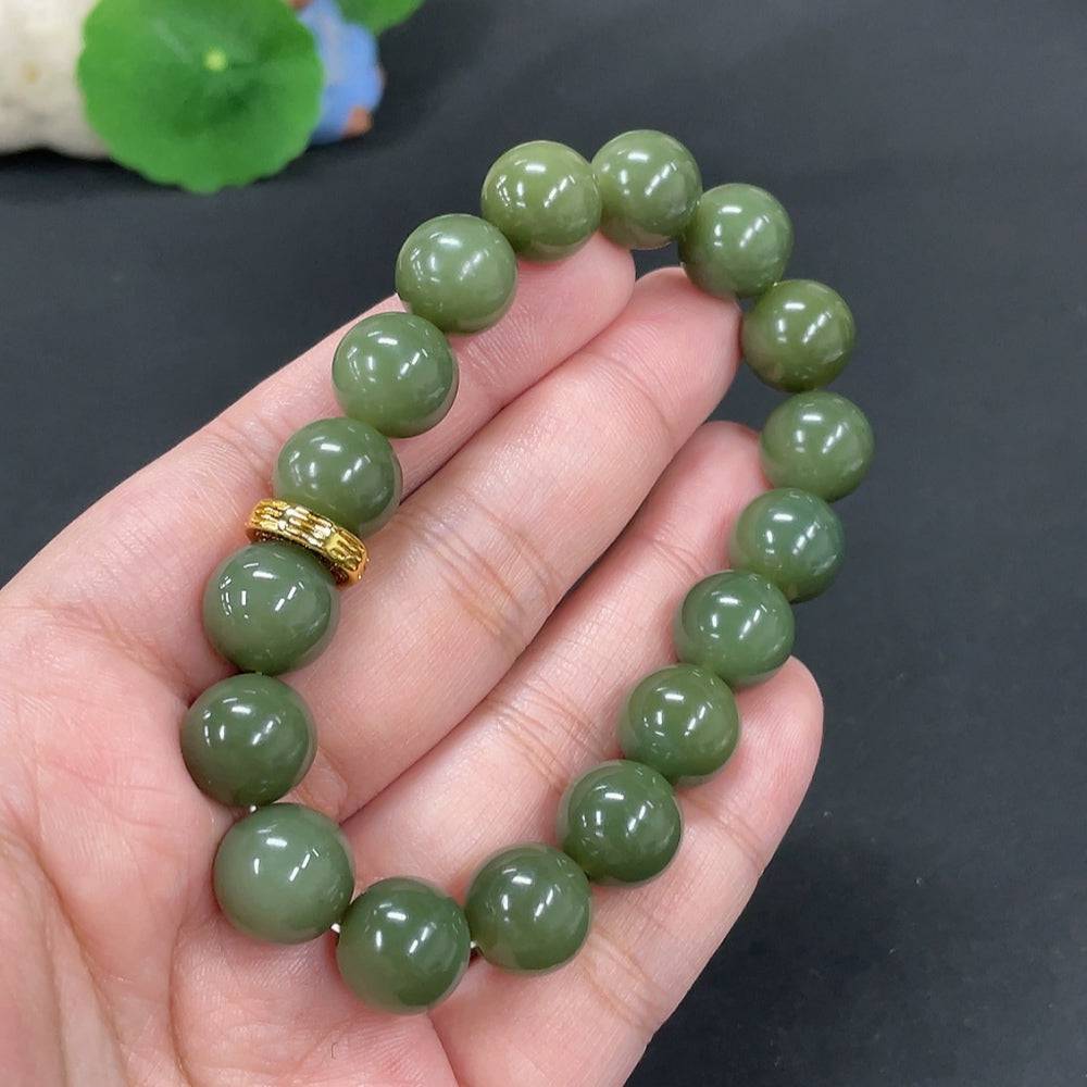Huiliu certified Hetian jade bracelet with 12mm smooth, polished jade beads, showcasing elegant craftsmanship and natural stone appearance.