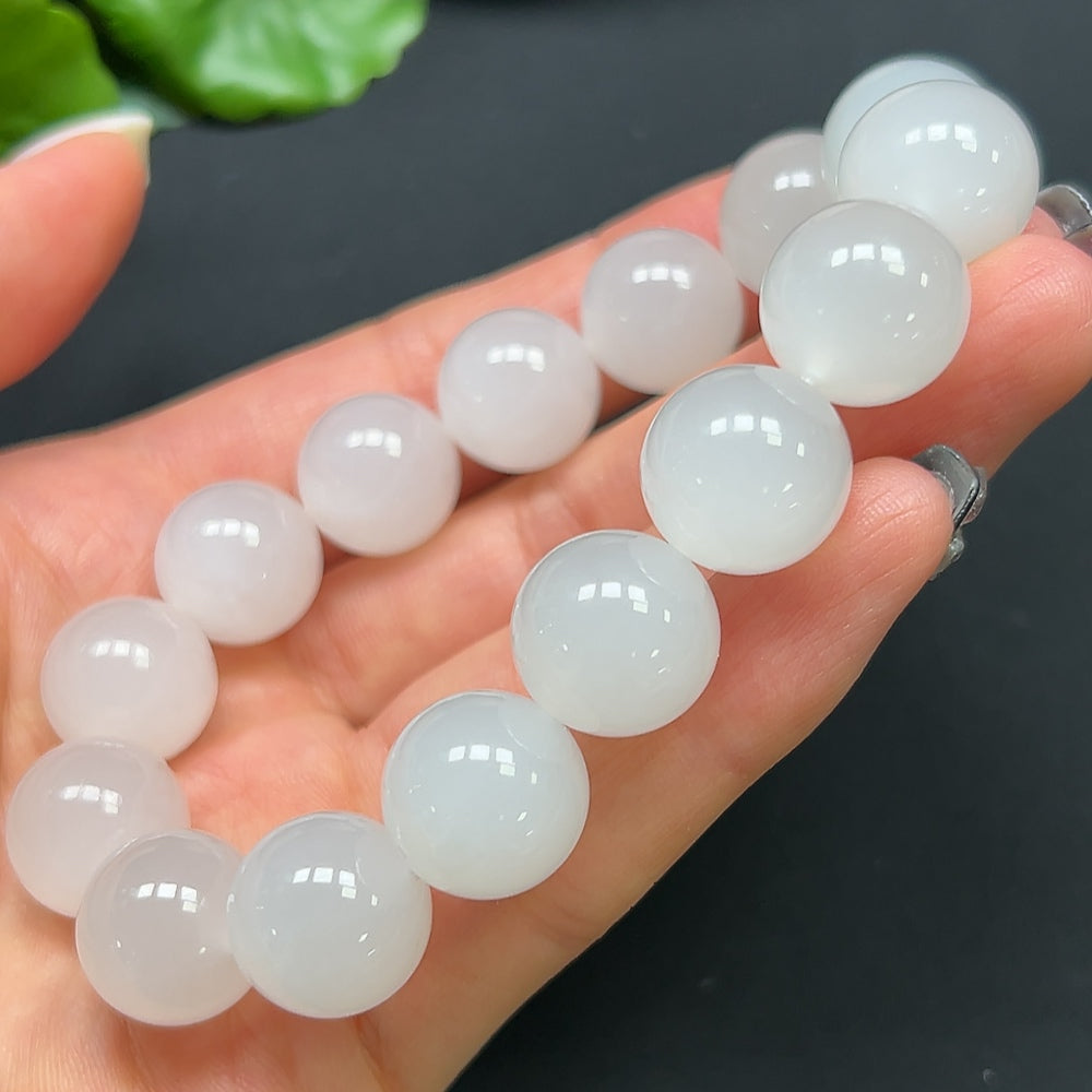 HKHQ Hetian Jade bracelet featuring 14mm smooth, polished jade beads on a flexible cord, displayed on a neutral background.