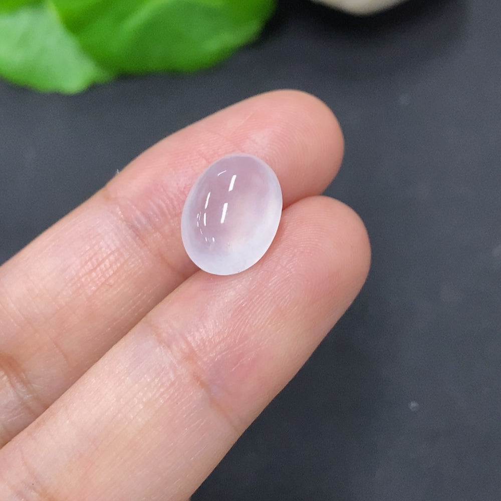 Close-up of a 1g jadeite cabochon jewelry piece by HKHQ, showcasing its smooth, polished green gemstone surface.
