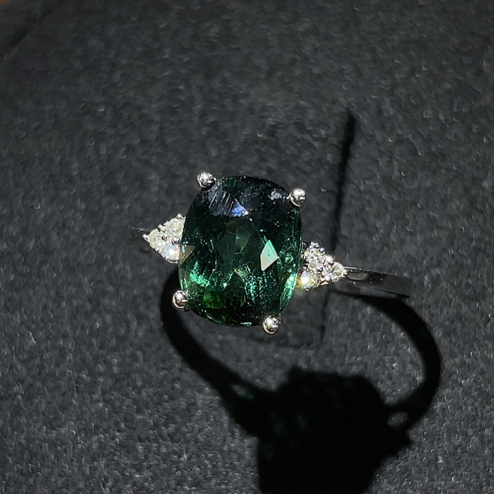 HKHQ tourmaline ring with gold setting and diamond accents, showcasing a vibrant gemstone and elegant jewelry design