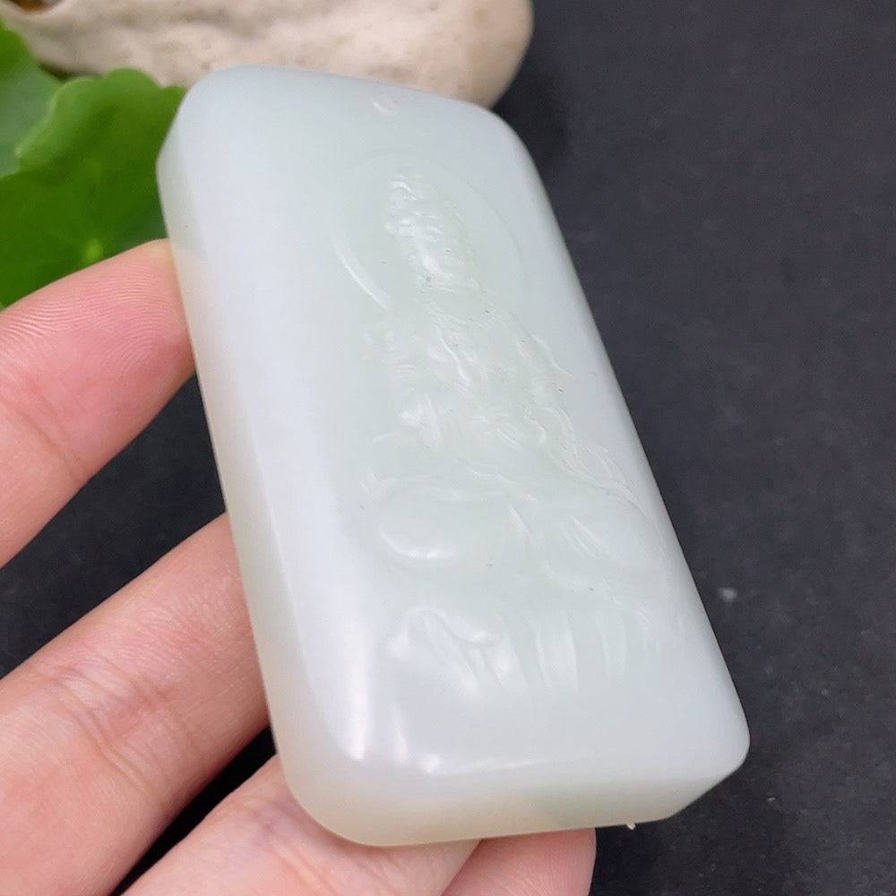 Huiliu certified Hetian jade Guanyin pendant featuring intricate carving and smooth, polished surface.