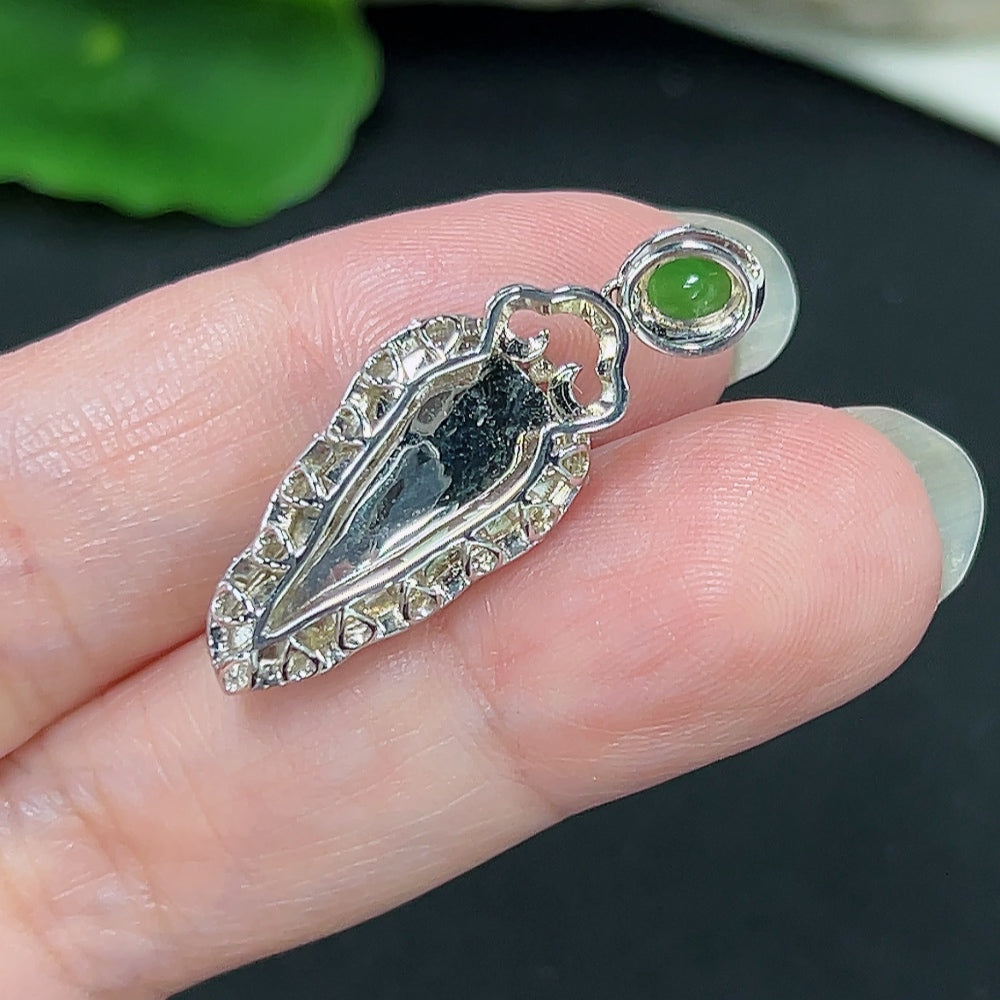 Jadeite leaf pendant with diamond accents, 18K gold, made by HKHQ, showing close-up of detailed leaf design and gold setting.