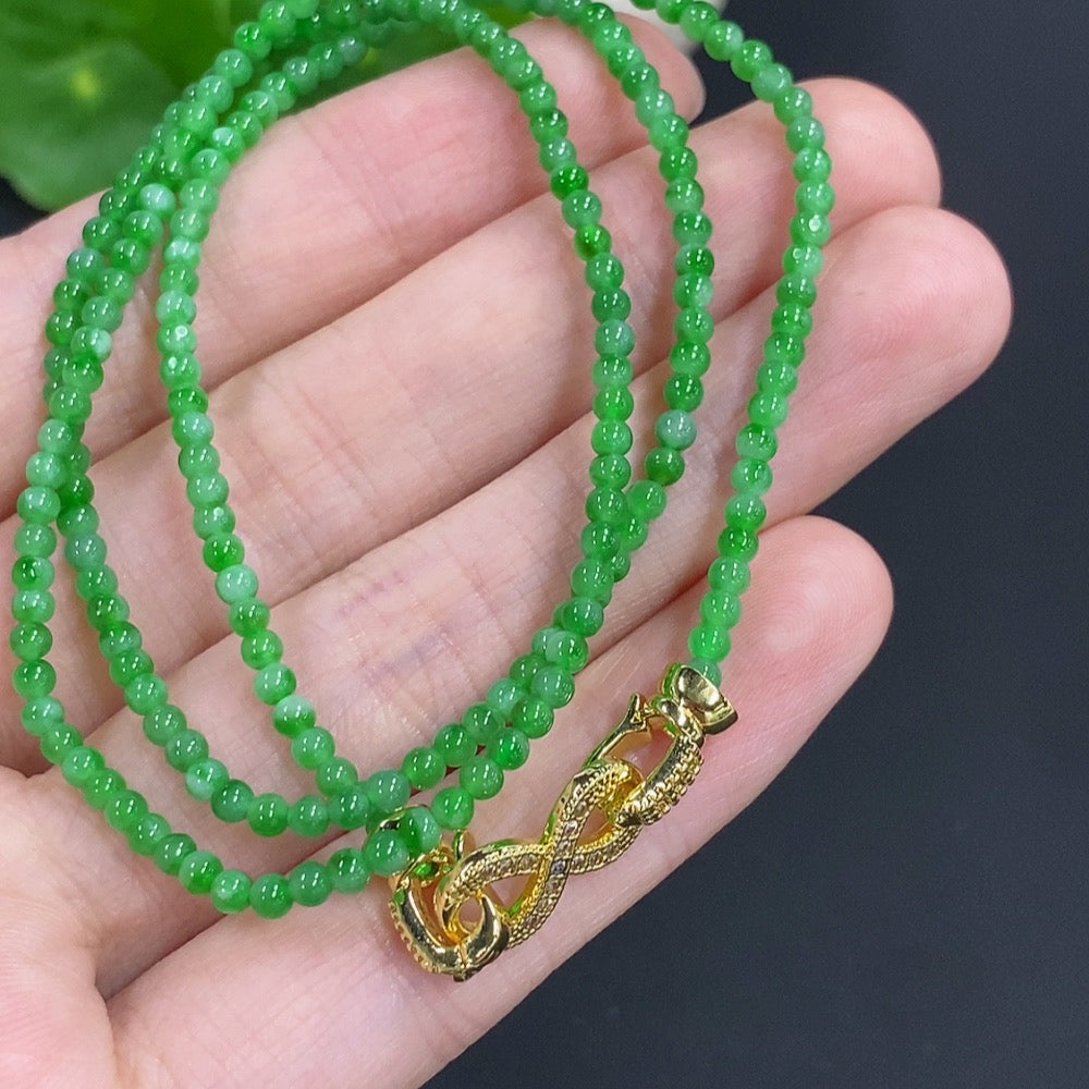 Jadeite bead necklace from HKHQ featuring smooth green jade beads, non-gold design, weighing 7.7g, close-up view.