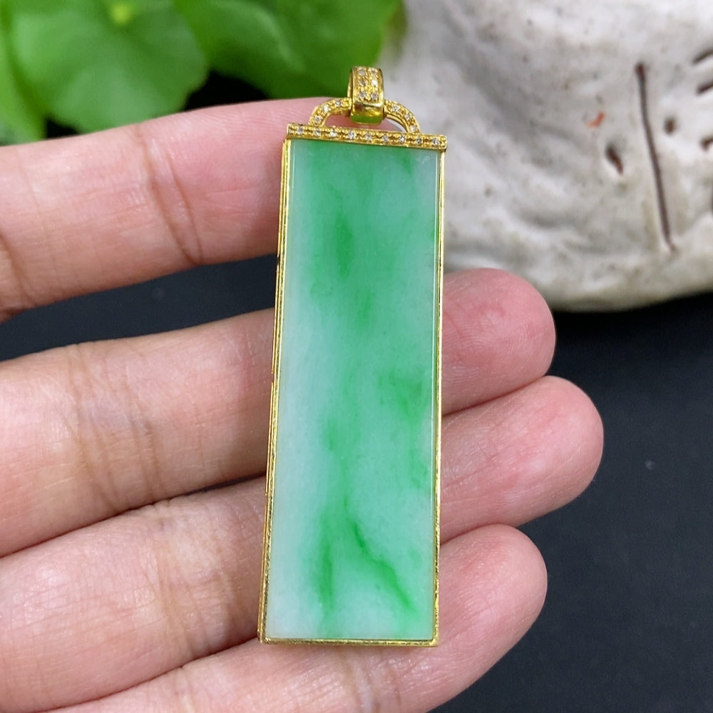 Jadeite plain pendant necklace with 18K gold setting and diamond accent, weighing approximately 10g, styled with elegant jewelry.