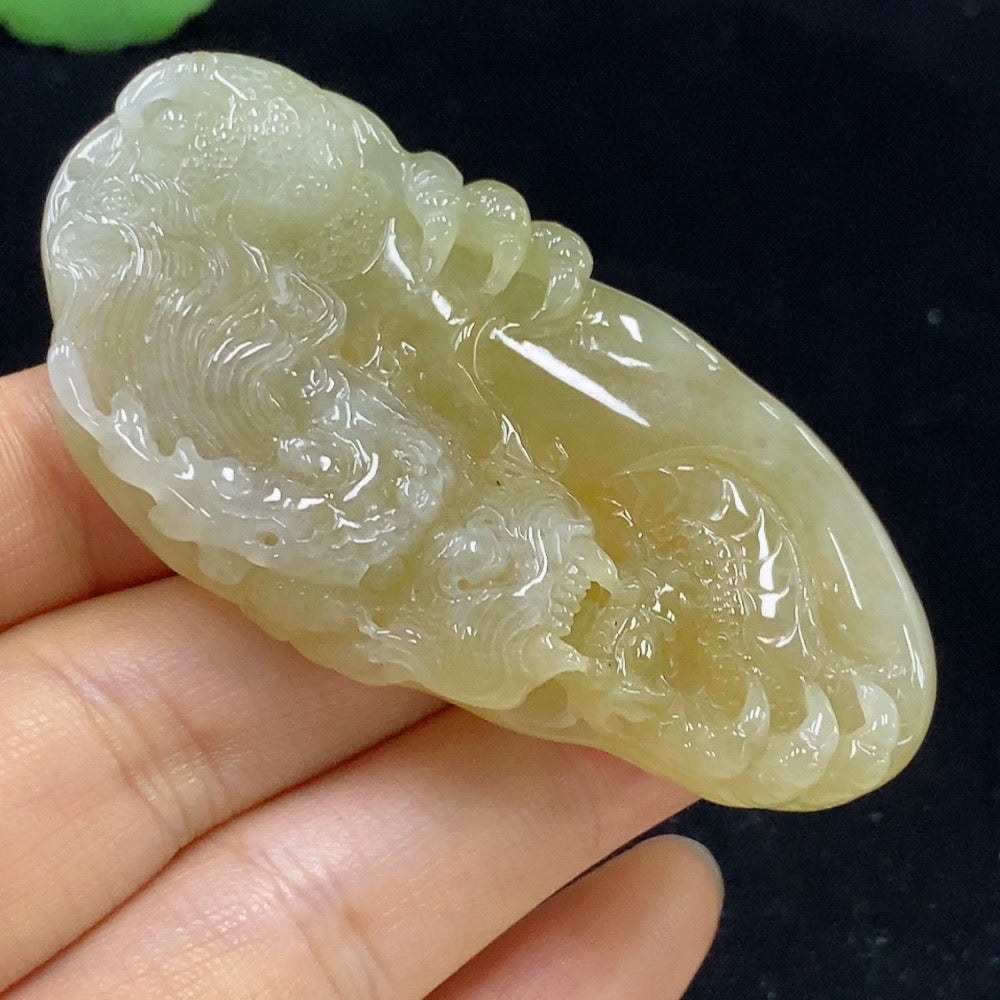 Jadeite dragon pendant from HKHQ, showcasing a detailed green jade dragon design, weighs approximately 34.71 grams.