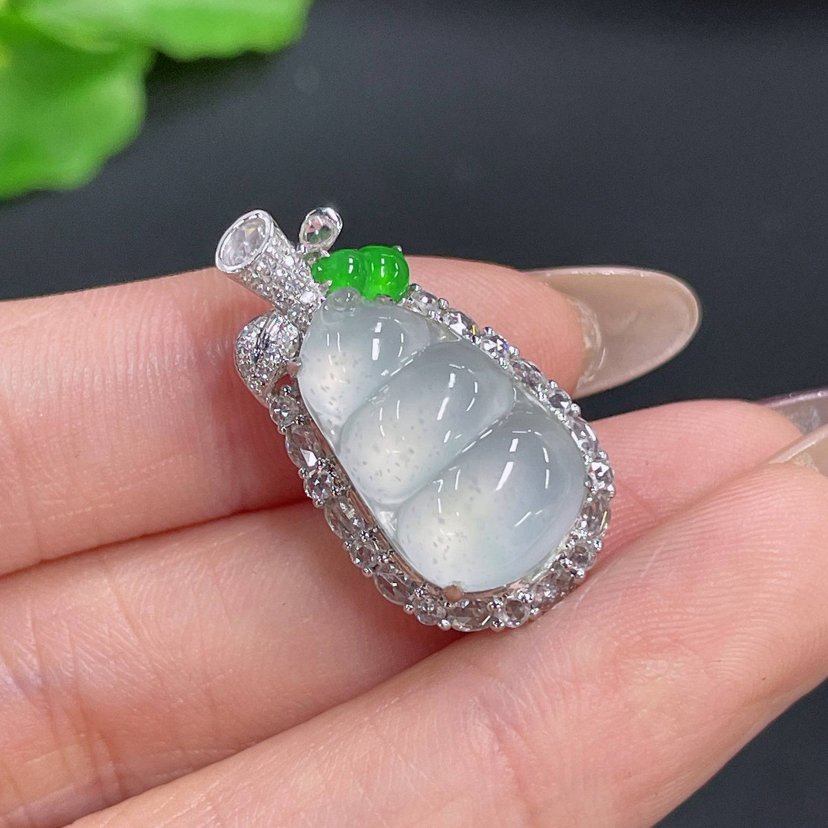 Huiliu Jadeite bean pendant with diamond inlay, featuring polished jade and sparkling diamonds, on a delicate chain.