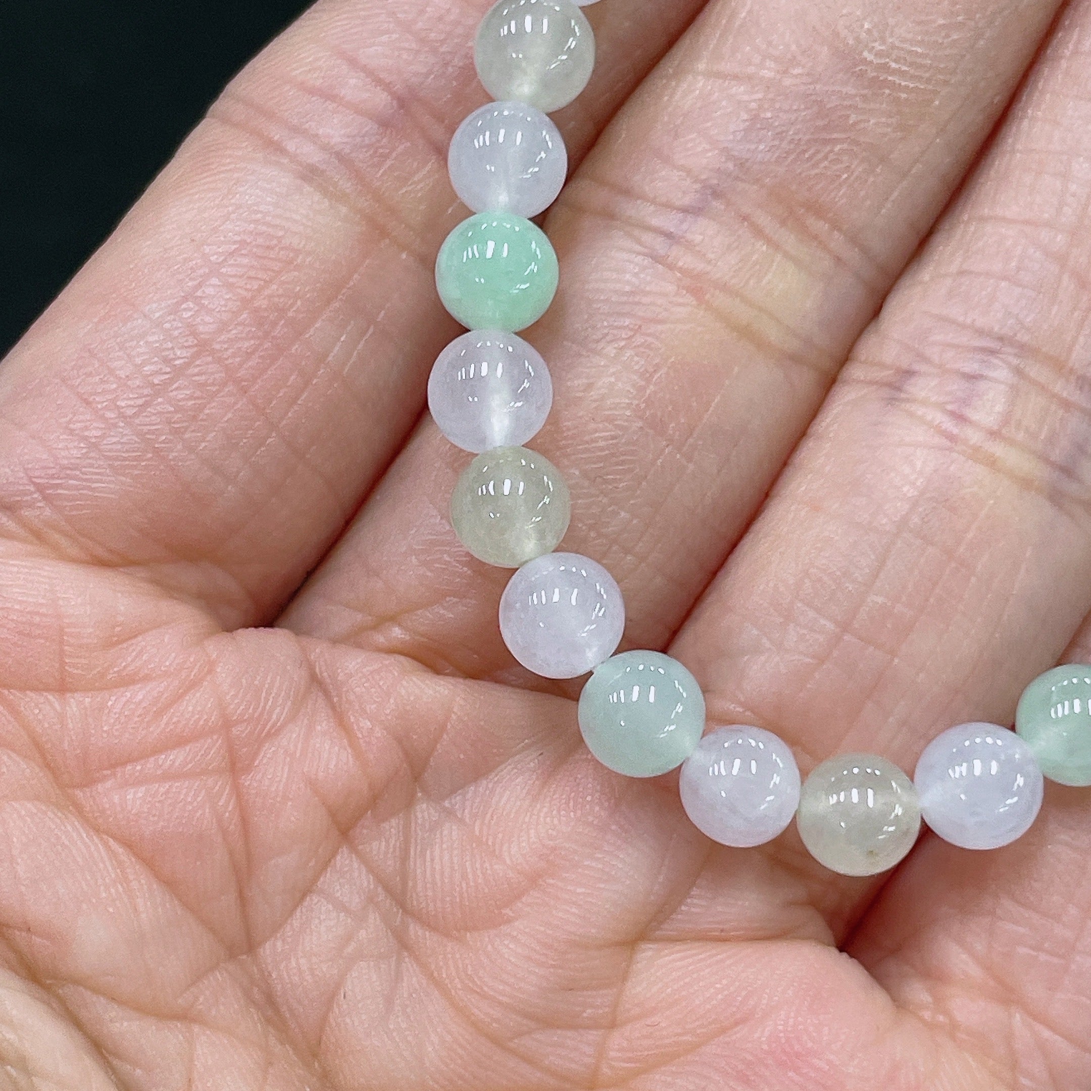 HUILIU HQ jadeite bracelet with 5.6mm beads, weighing approximately 10.12g, showcasing smooth, polished green jade stones.