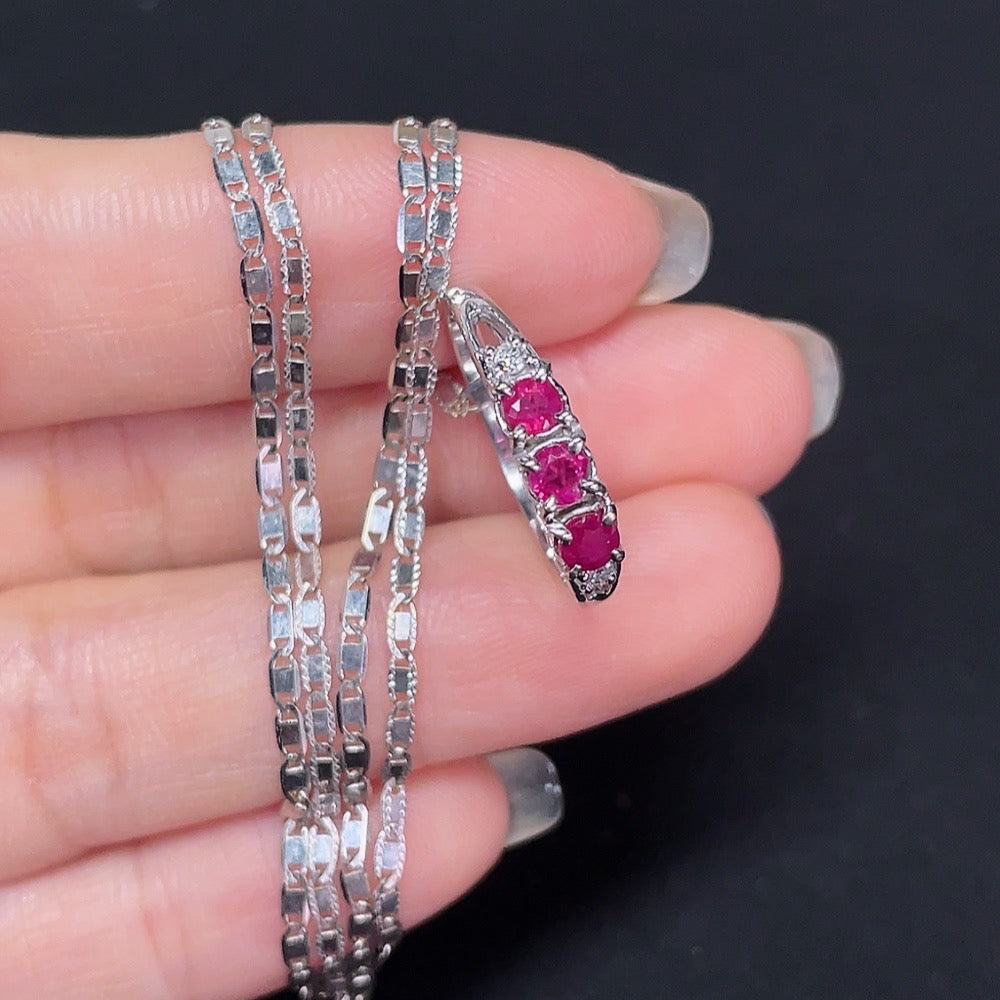 18k gold Ruby inlaid ring with diamond accents, size 13, displayed with chain, weighing approximately 4.69 grams.