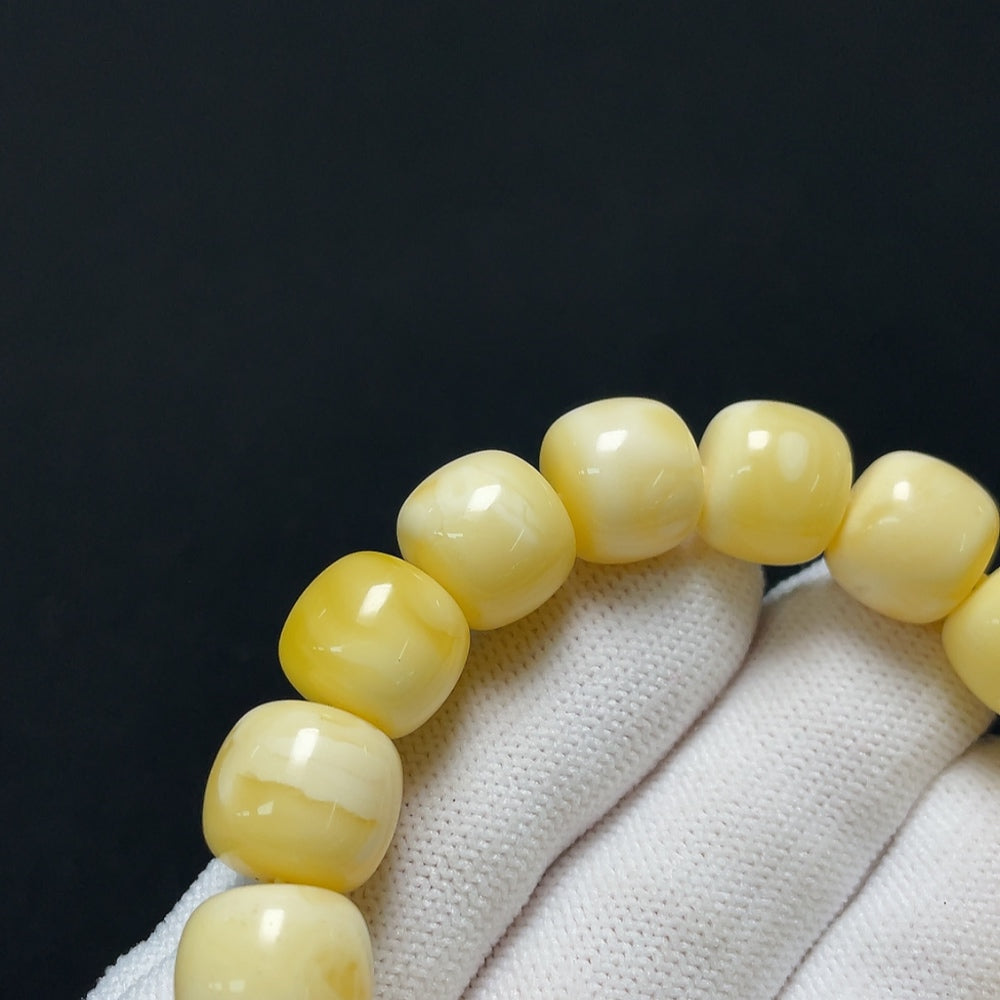 Amber Beeswax Bracelet by HKHQ featuring natural amber beads and a secure clasp on a neutral background.