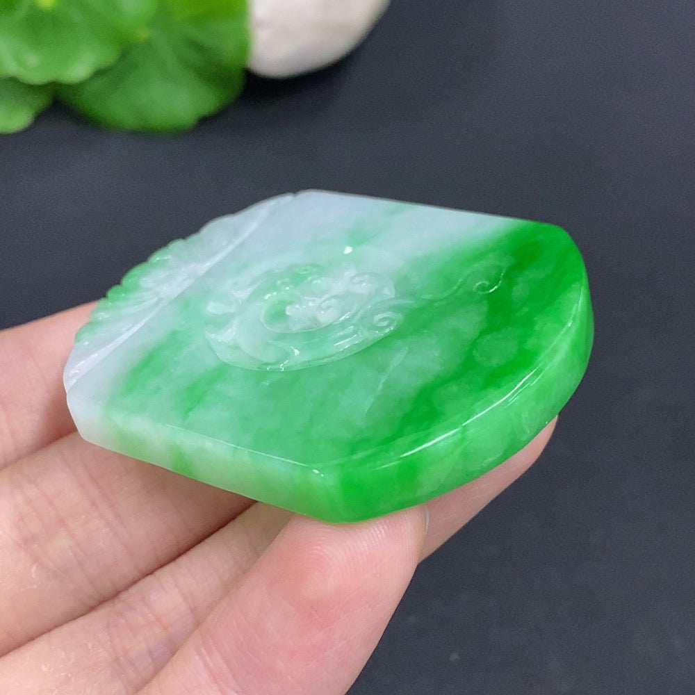 Antique jadeite pendant from HKHQ featuring a polished jade pendant with intricate carvings, weighing approximately 35.1 grams.