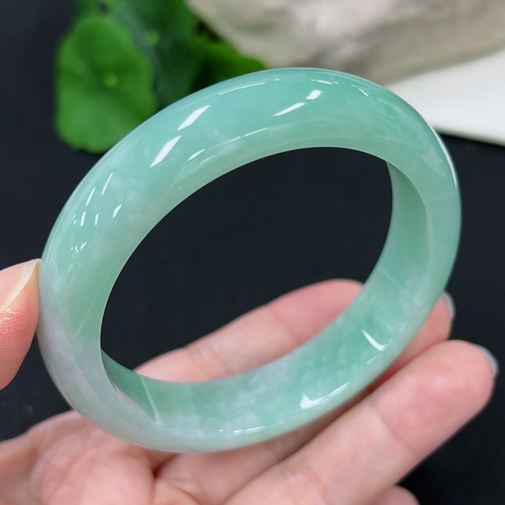 HKHQ Jadeite round bangle, size 57.7, weighs approx. 66g, showcasing smooth, polished jadeite jewelry on a neutral background.