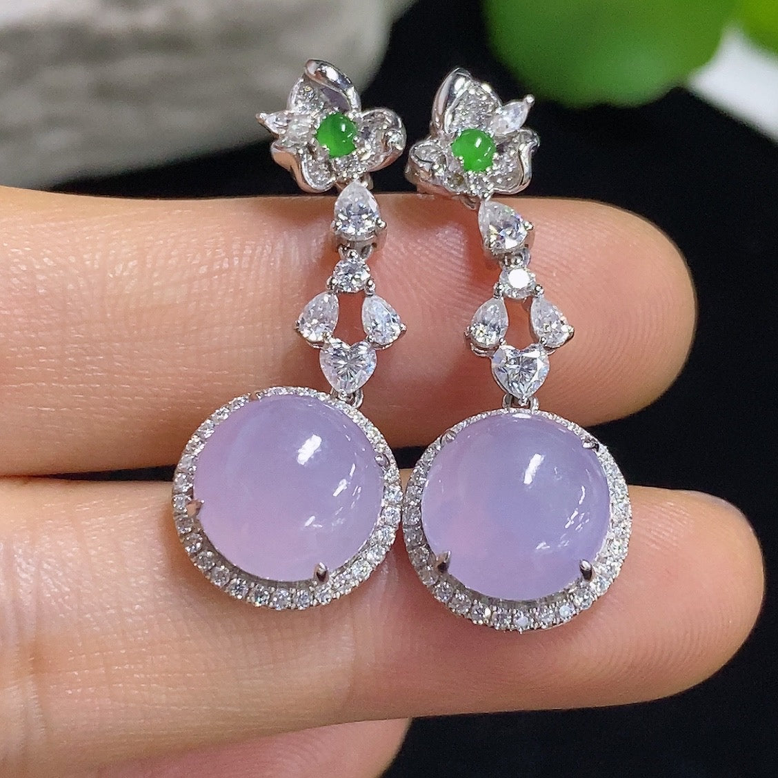 HKHQ jadeite cabochon earrings with 18K gold setting, showcasing smooth, polished green jade stones in a stylish earring design