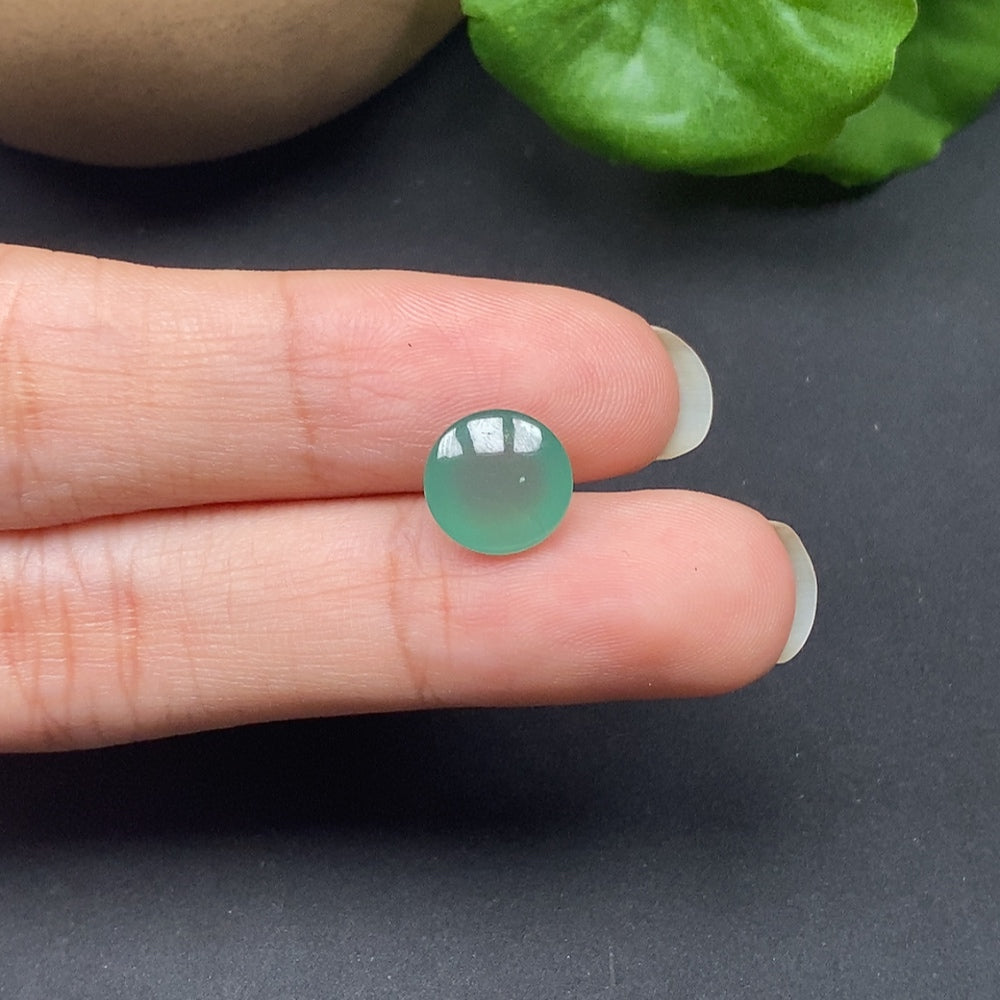 Close-up of a HKHQ jadeite cabochon inlay showing smooth, polished green jade surface with subtle natural variations.