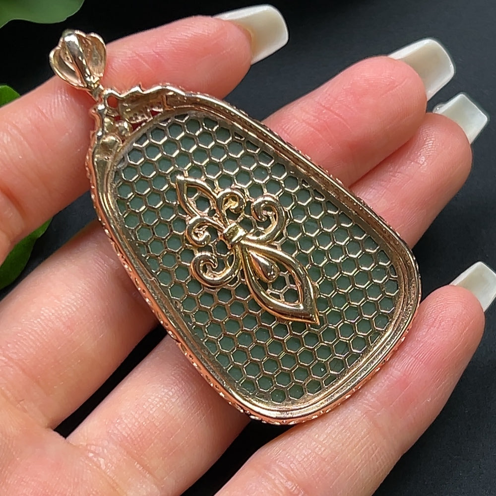 Hetian jade plain pendant with 18K gold and diamond inlay, displayed on a necklace chain.