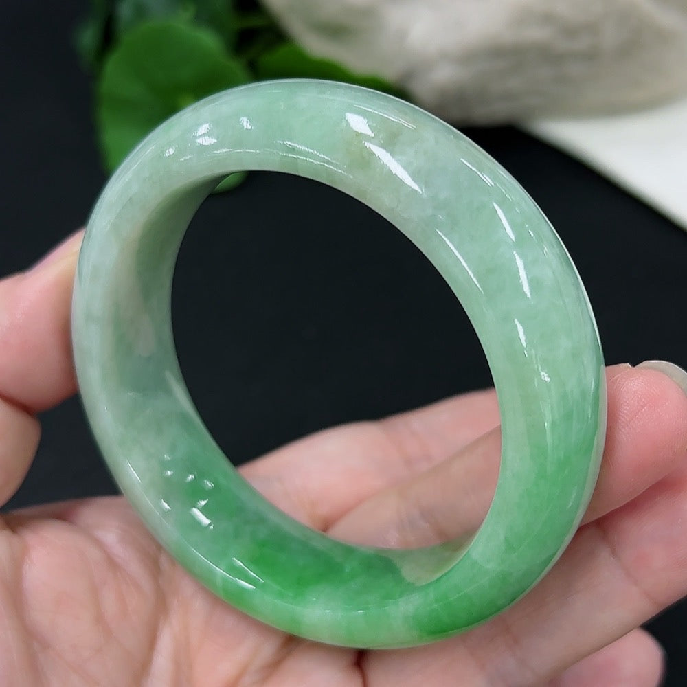 Jadeite round bangle in size 53.6, crafted from green jade, weighing approximately 82 grams, by HKHQ.