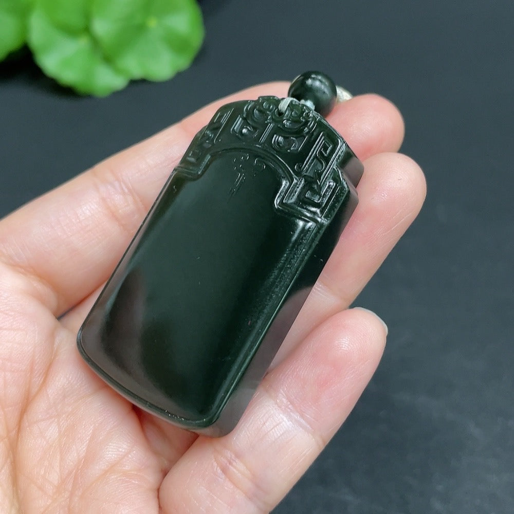 Huiliu Hetian Jade pendant with antique plaque and rope, showcasing smooth, polished green jade with intricate carvings.