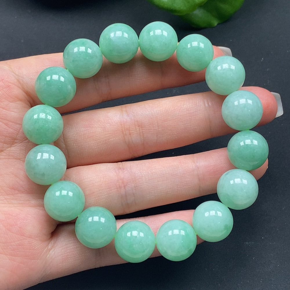HKHQ jadeite bracelet in size 12.8 with a total weight of 57.85g, featuring smooth, polished jadeite beads.