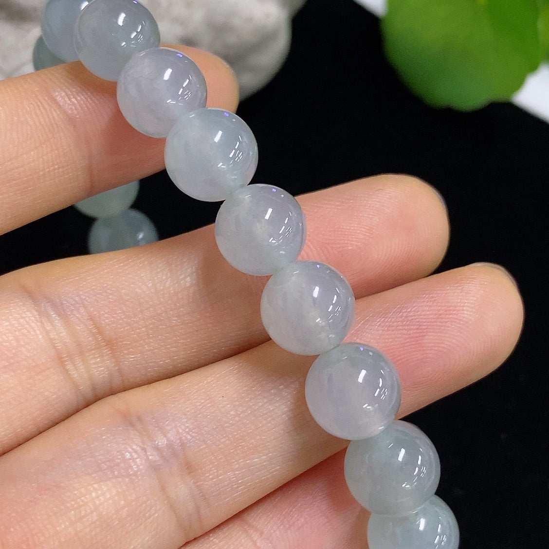 Jadeite bracelet weighing 28.68g with smooth, polished green jadeite beads, crafted by HKHQ, displayed on a neutral background.