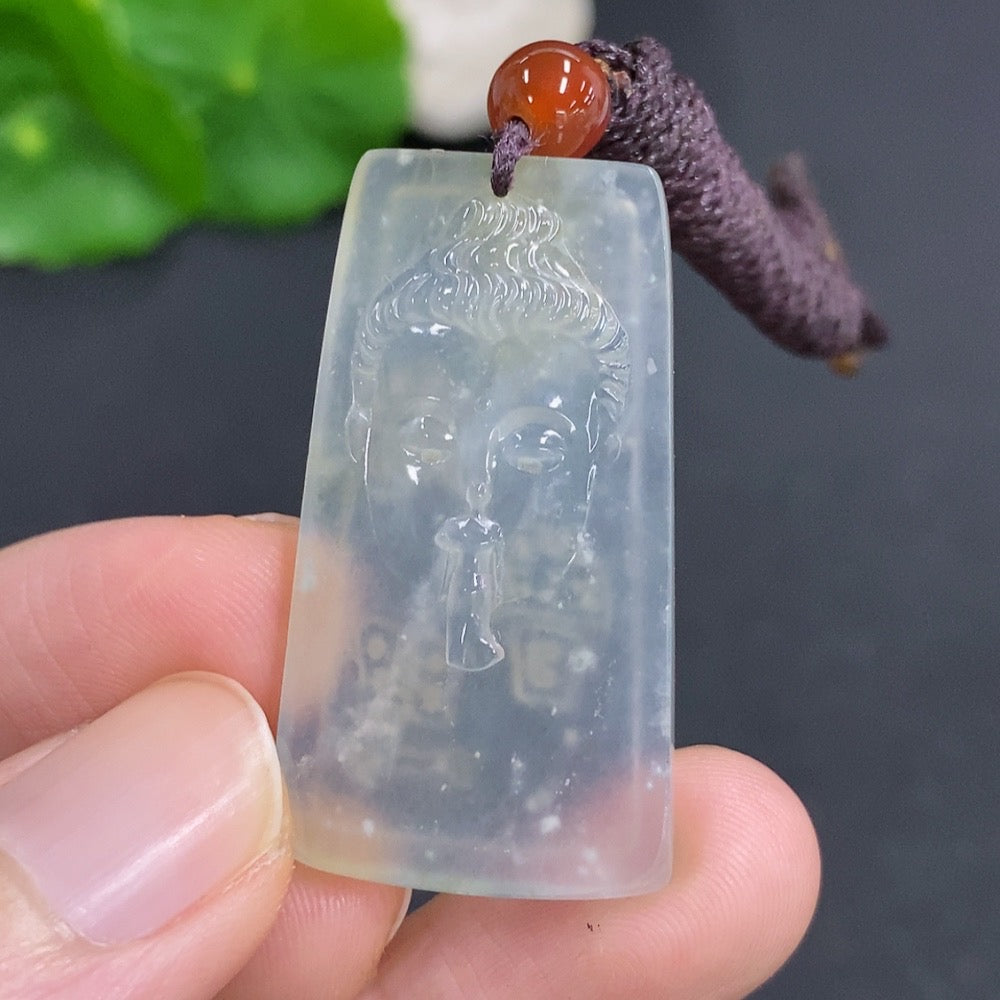 Jadeite Buddha pendant with detailed carving, weighing about 9.3g, displayed on a rope, from HKHQ.