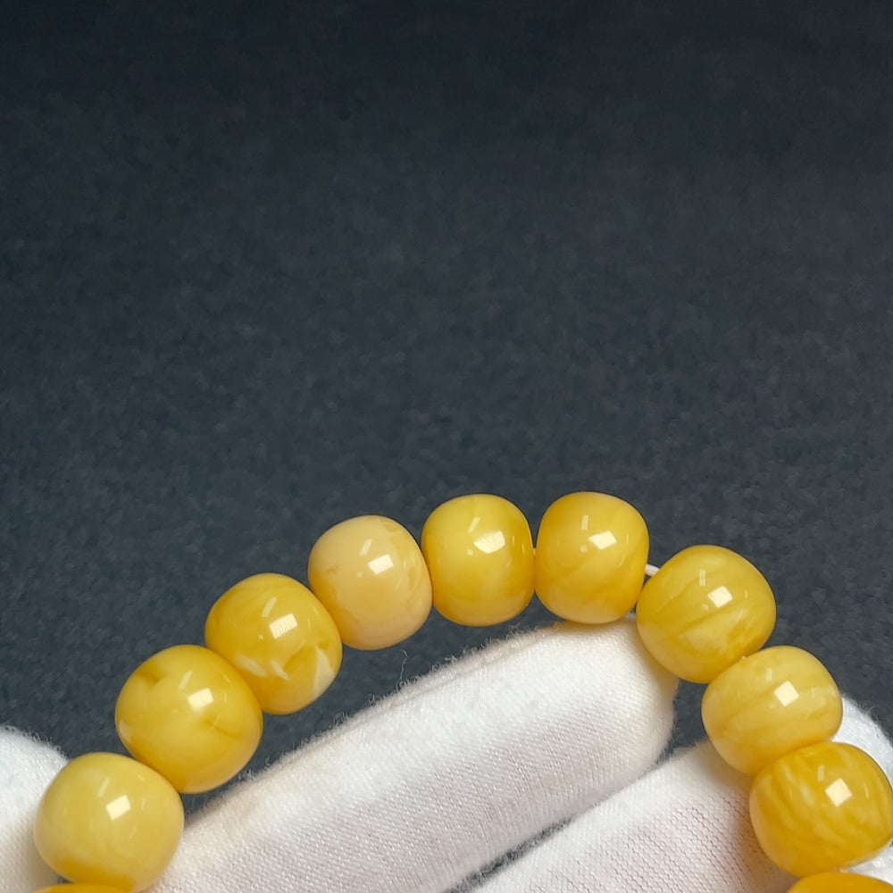 Amber Beeswax bracelet with Southern Red Agate beads by HUILIU HQ, showcasing warm amber tones and vibrant red stone accents.
