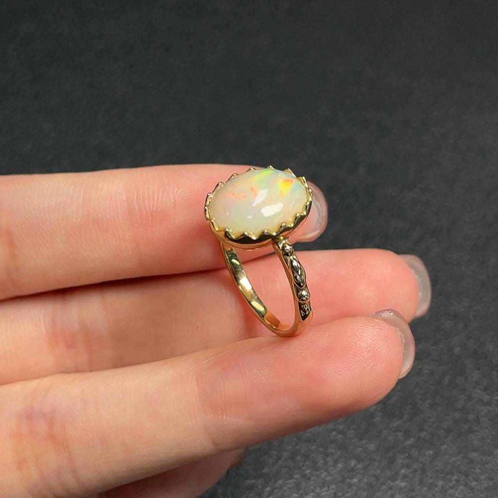 Huiliu certified opal gemstone ring with 37% gold content, showcasing a vibrant, polished opal gemstone on a gold band.