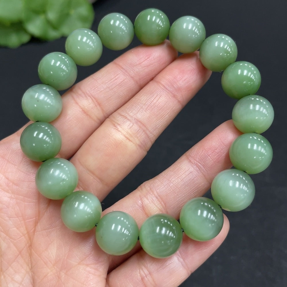 Hetian Jade Jasper bracelet with 11.7mm beads, crafted by HUILIU HQ, showcasing smooth, polished jade stones on a string.