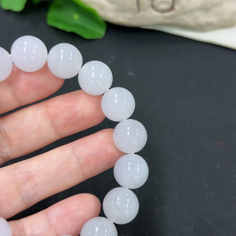 HKHQ jadeite bracelet with 12.8mm beads, weighing approximately 58.1g, showcasing smooth, polished green jadeite stones.