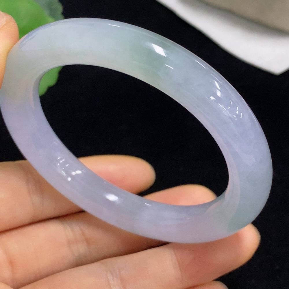 Huiliu Certified Jadeite round bangle with smooth, polished surface, showcasing its vibrant green color and elegant craftsmanship.