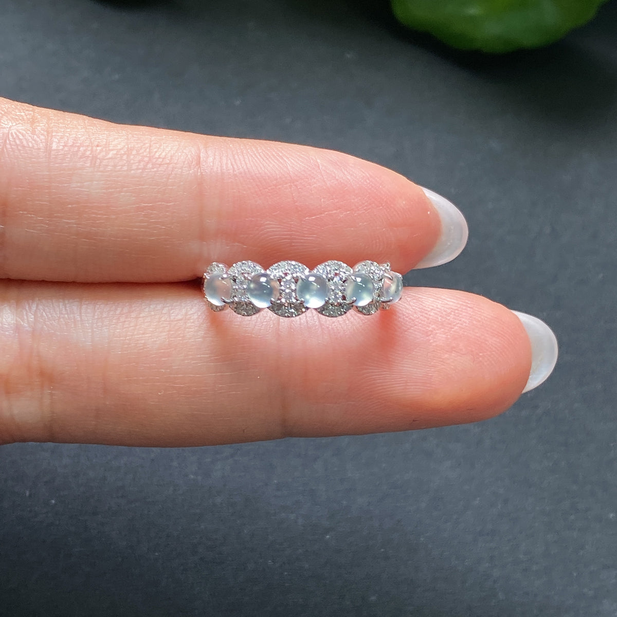Jadeite ring in 18K gold with diamond accents, featuring a smooth jadeite gemstone set in a polished gold band.