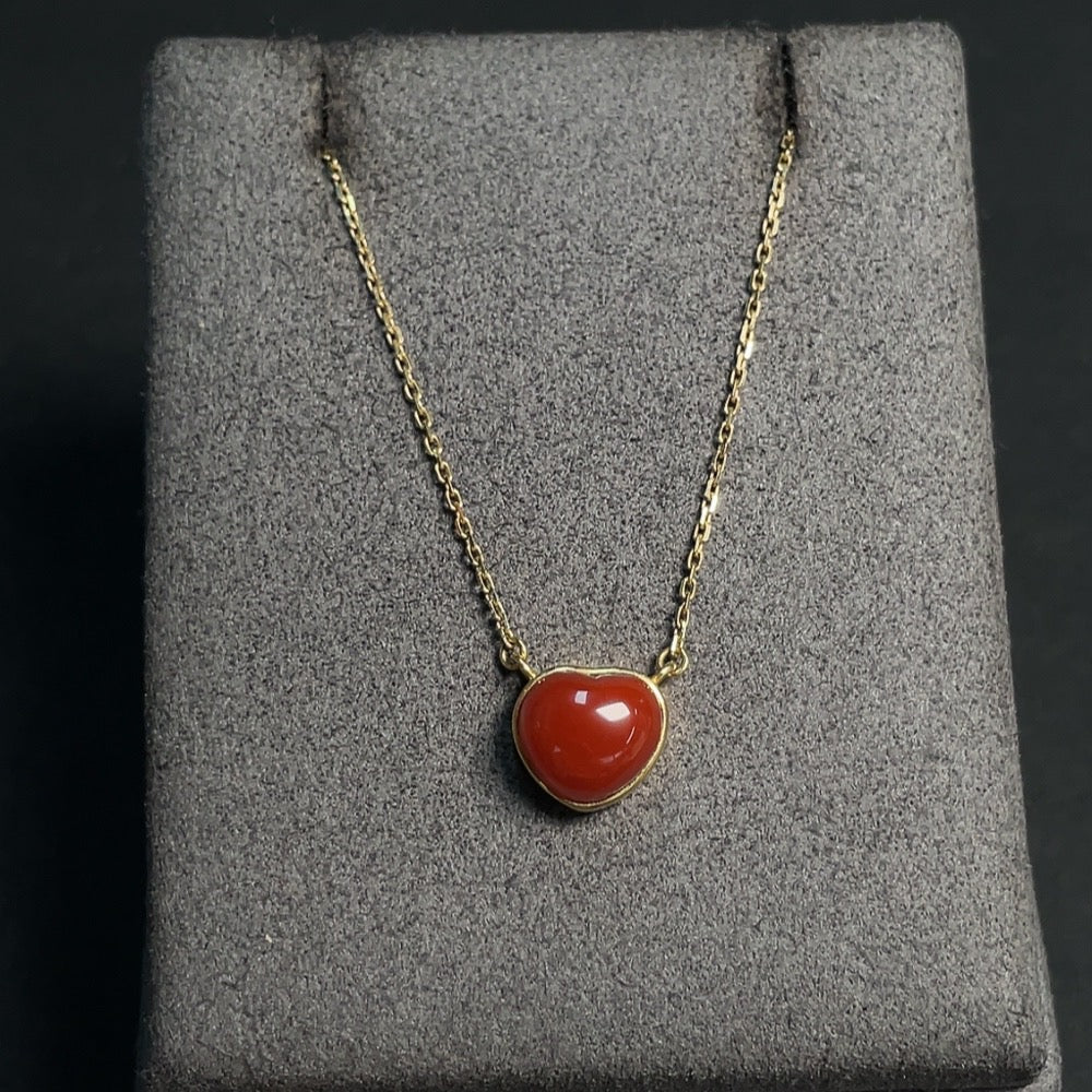Red agate inlaid gemstone necklace with 18K gold chain and visible organic matter, crafted by HKHQ.
