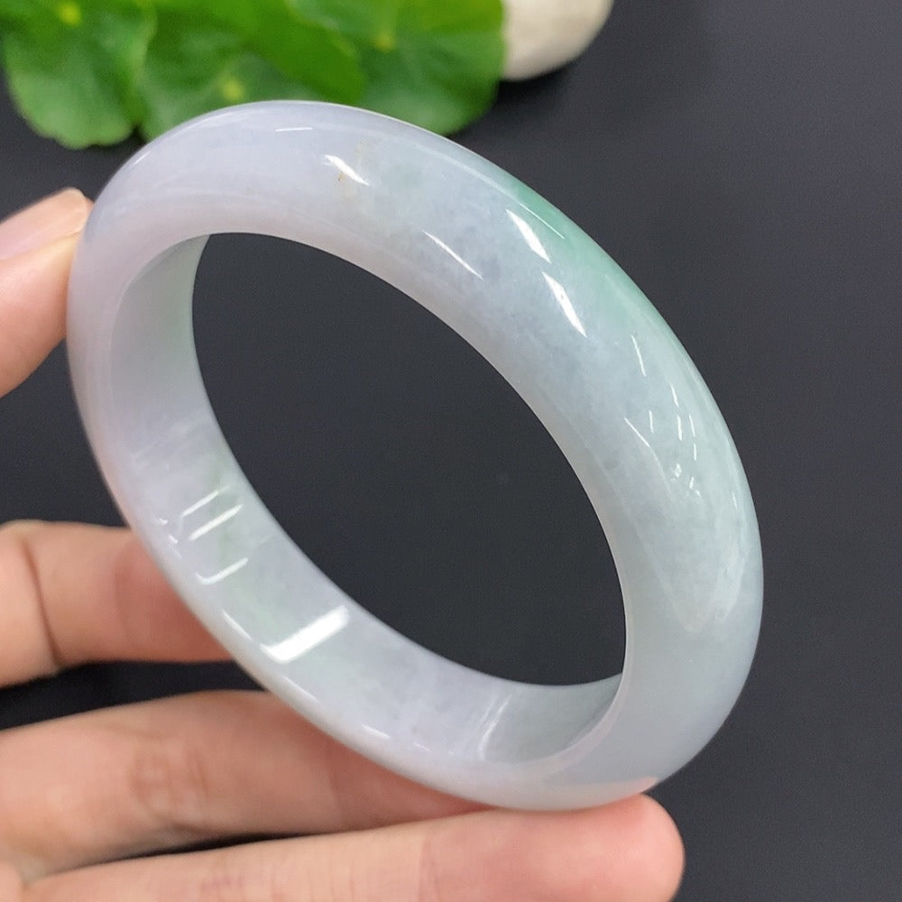 Jadeite round bangle with a 61.2g weight and size 57, featuring smooth, polished jadeite from HKHQ on a plain background.