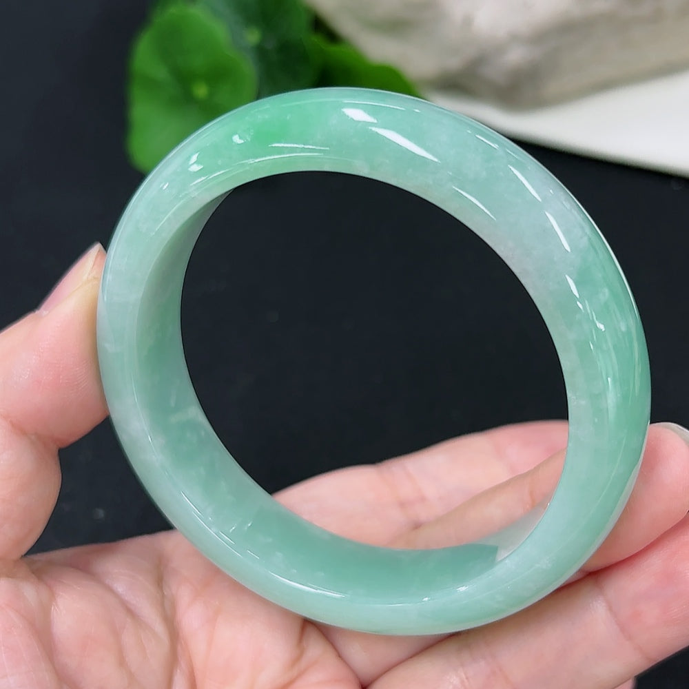 HKHQ jadeite round bangle in size 57.7 with a total weight of 66g, showcasing smooth, polished green jadeite bracelet.