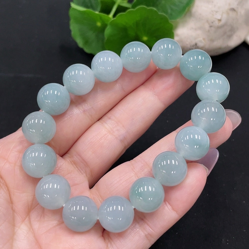 HKHQ Jadeite bracelet with 12.5mm jade beads, Huiliu certified, showcasing smooth, polished green jade stones.