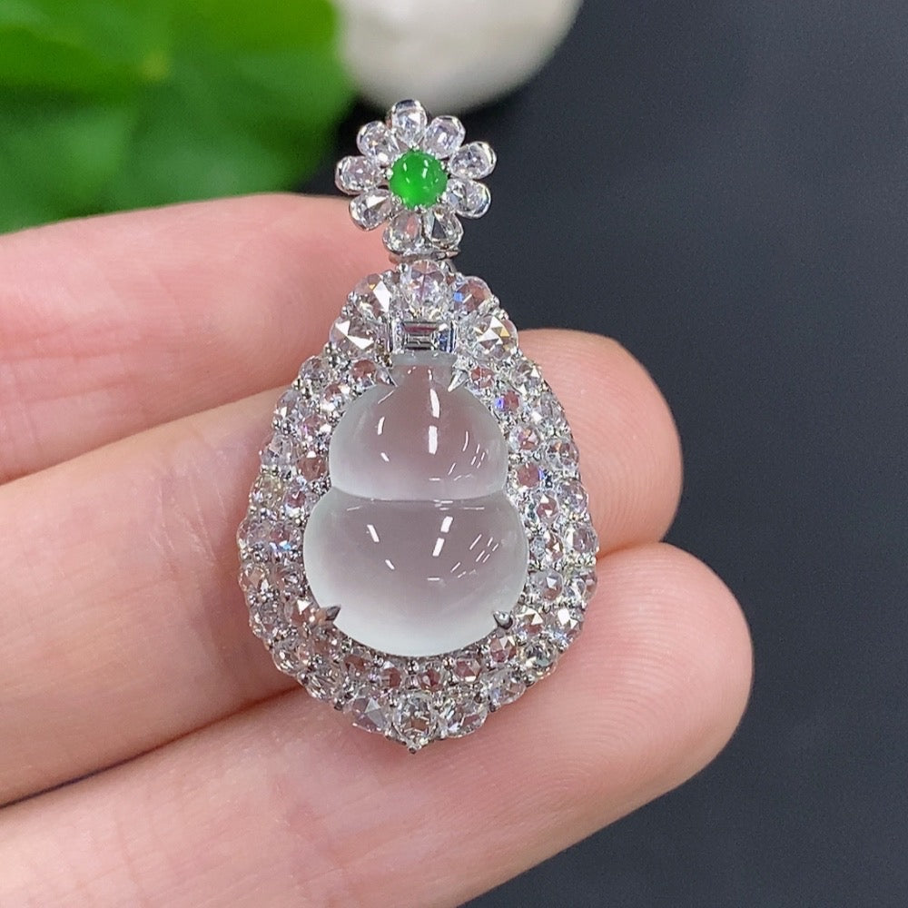 Jadeite gourd pendant with 18K gold mounting, accented with diamonds, featuring a smooth green jade stone and gold setting.