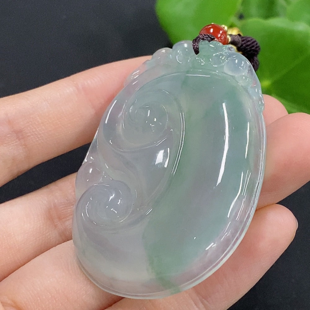 Jadeite Ruyi pendant necklace with intricate carved design, featuring a smooth, polished jadeite stone on a delicate cord.