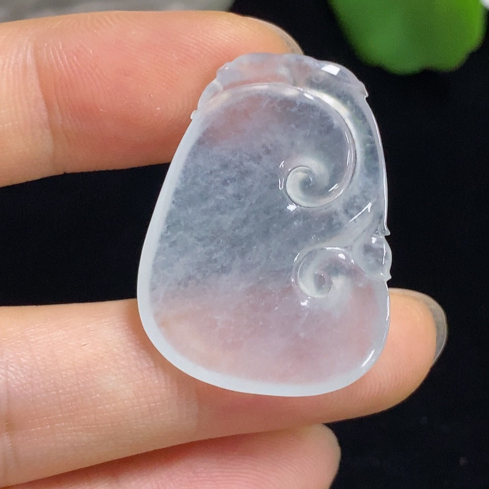 Jadeite Ruyi carving with inlaid setting, intricate jewelry piece showcasing detailed craftsmanship and smooth, polished surfaces.
