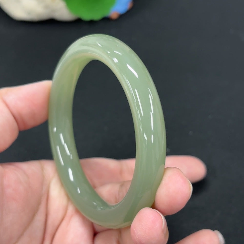 HKHQ Hetian Jade round bangle, size 56.9, weighing approx. 49.3g, showcasing smooth, polished jade surface and elegant design.