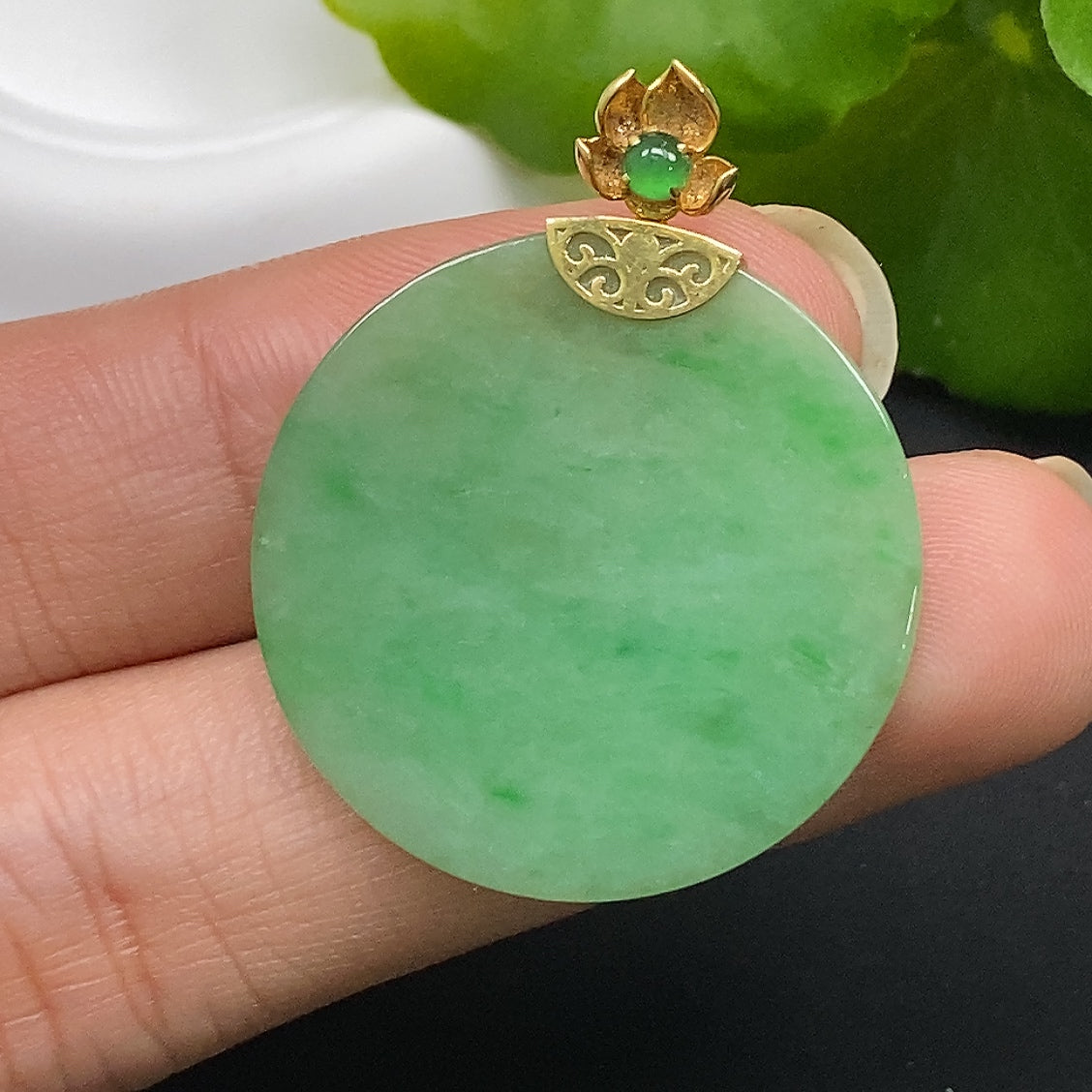 Jadeite plain pendant with 18k gold setting, smooth jade surface, and delicate gold accents, weighing approximately 5.51g.