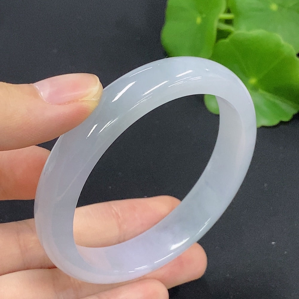 HKHQ jadeite round bangle, size 54.8 with a polished surface, showcasing its smooth, vibrant green jadeite material.
